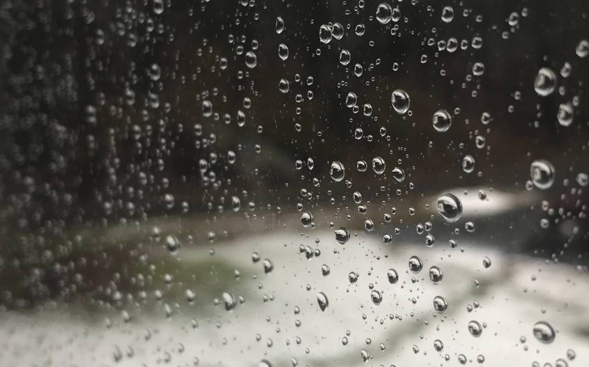 Raindrops cling to a windowpane in Bath Friday morning during a wet and windy storm. By 9:45 a.m., more than 44,000 Central Maine Power customers were without electricity as the storm barreled through Maine. (John Swinconeck / Spectrum News Maine)